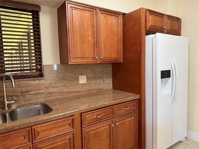 a kitchen with stainless steel appliances a refrigerator and a sink