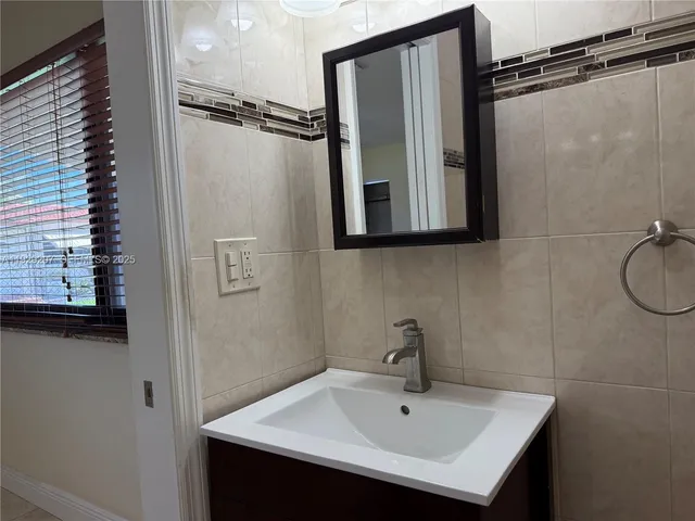 a bathroom with a sink and mirror
