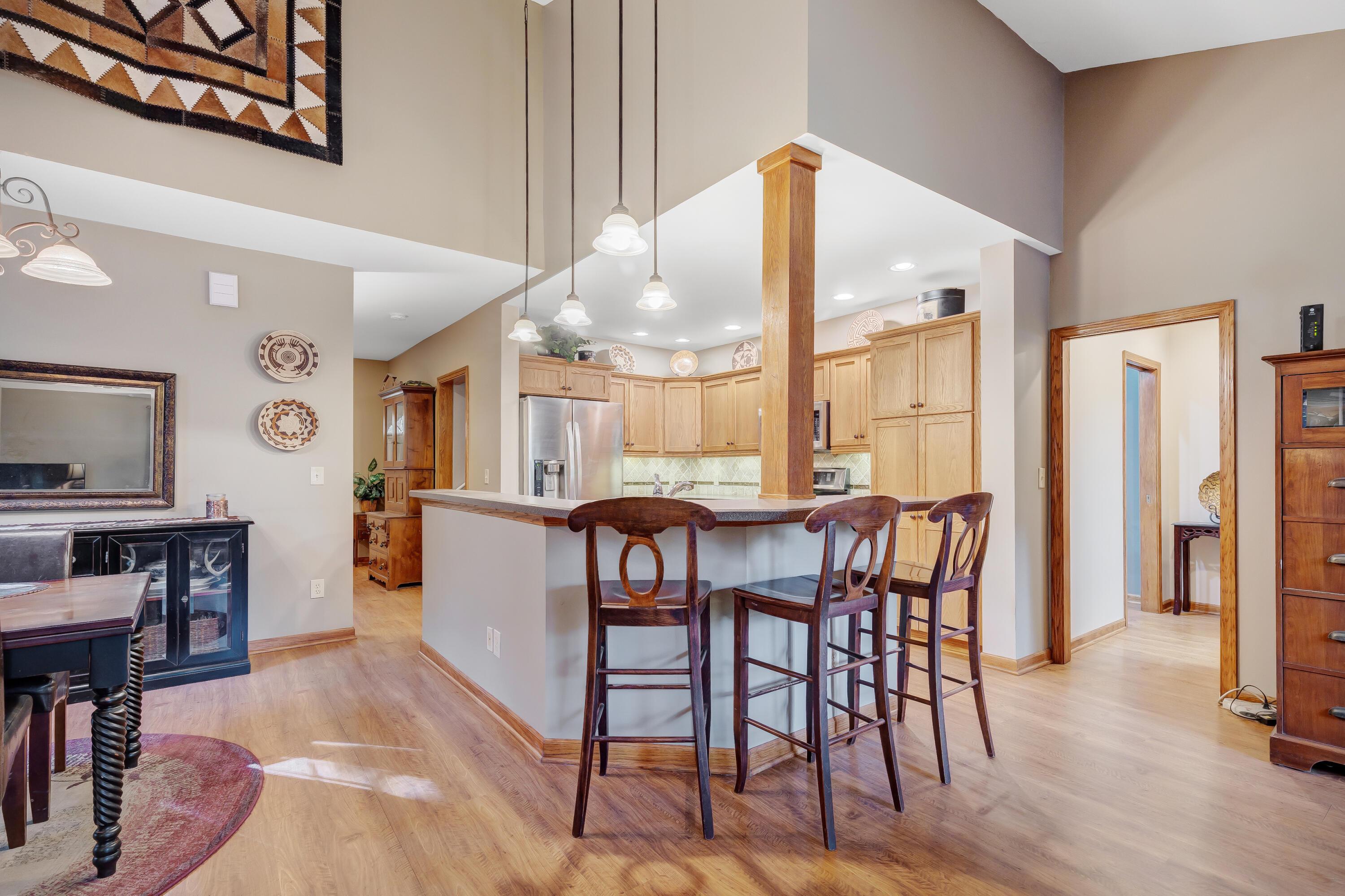 6681 Harlem Road Westerville, OH 43082 - Photo 21 of 78 • Laminate flooring • Tan painted walls • Pendant lighting • Laminate countertops with bevelled edge • Breakfast bar ledge • New LG® refrigerator ~ 2019 • New LG® microwave ~ 2019 • New LG® electric range ~ 2019 • New LG® dishwasher ~ 2019 • Framed cabinets • Wall pantry • Can lighting • Double bowl, stainless steel sink with sprayer • Tumbled marble backsplash