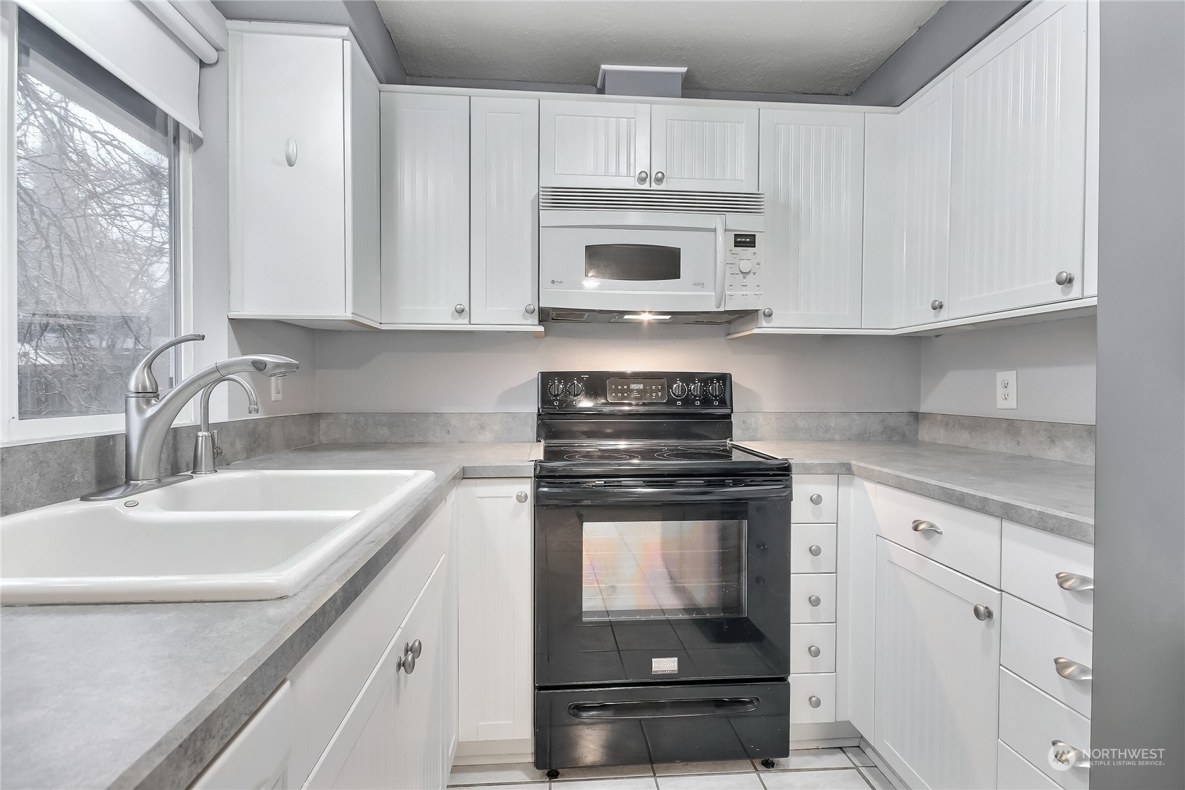 632 217th Street Southwest Bothell, WA 98021 - Photo 11 of 23 a kitchen with stainless steel appliances granite countertop a sink stove and white cabinets