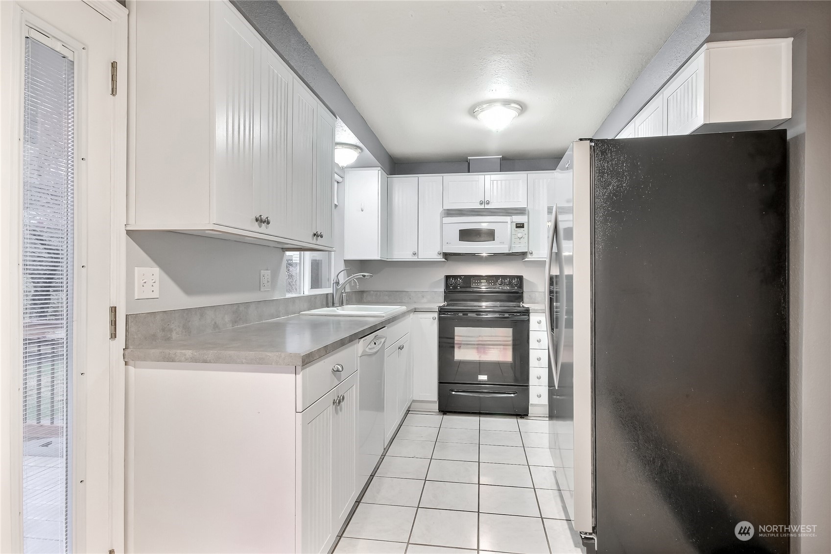 632 217th Street Southwest Bothell, WA 98021 - Photo 9 of 23 a kitchen with stainless steel appliances a refrigerator sink and cabinets