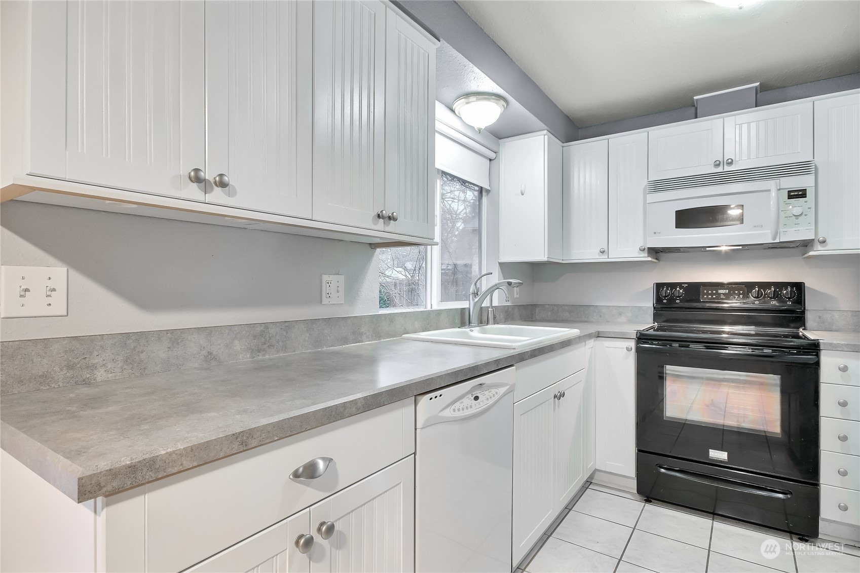 632 217th Street Southwest Bothell, WA 98021 - Photo 10 of 23 a kitchen with granite countertop white cabinets and a stove