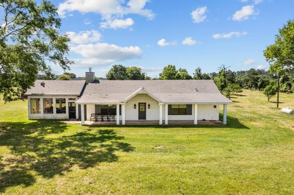 an aerial view of a house with a yard