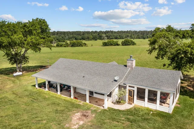 a aerial view of a house with garden and lake view