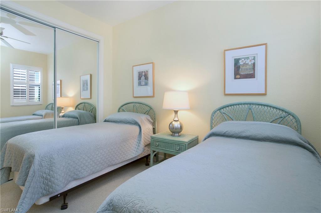 758 Regency Reserve Circle, Unit 2103 Naples, FL 34119 - Photo 15 of 41 a bedroom with two beds and painting on the wall