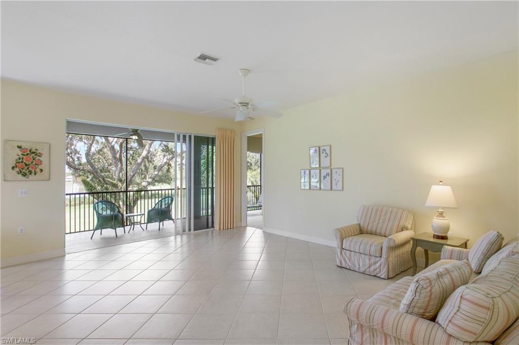758 Regency Reserve Circle, Unit 2103 Naples, FL 34119 - Photo 17 of 41 a living room with furniture and a large window with outer view