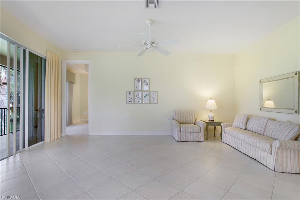 758 Regency Reserve Circle, Unit 2103 Naples, FL 34119 - Photo 18 of 41 a living room with furniture and a couch