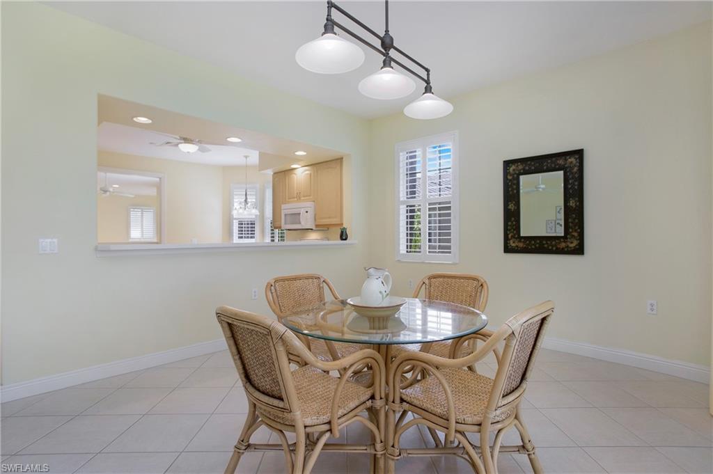 758 Regency Reserve Circle, Unit 2103 Naples, FL 34119 - Photo 20 of 41 a dining room with furniture and window
