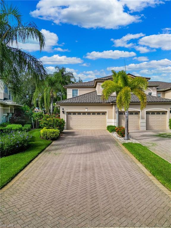 758 Regency Reserve Circle, Unit 2103 Naples, FL 34119 - Photo 2 of 41 a view of a house with a yard and potted plants