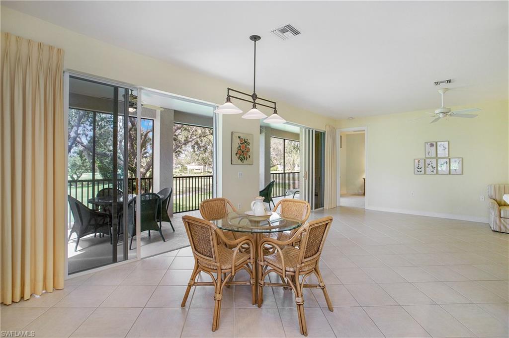 758 Regency Reserve Circle, Unit 2103 Naples, FL 34119 - Photo 21 of 41 a dining room with furniture large windows and a chandelier
