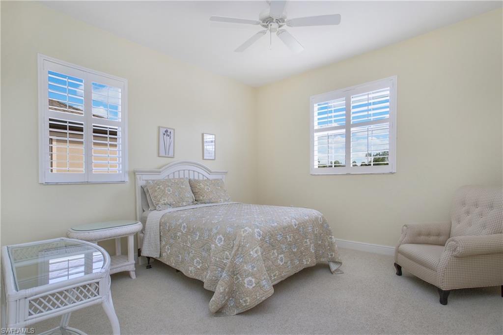 758 Regency Reserve Circle, Unit 2103 Naples, FL 34119 - Photo 23 of 41 a bedroom with a bed and a couch
