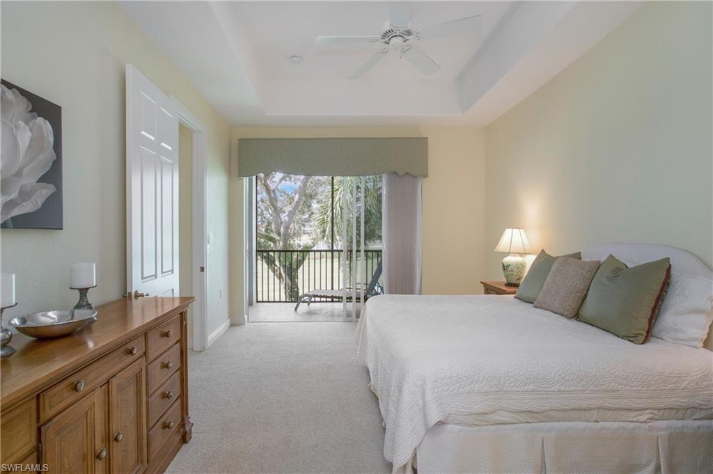 758 Regency Reserve Circle, Unit 2103 Naples, FL 34119 - Photo 27 of 41 a bedroom with a bed and a large window