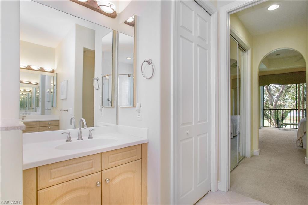 758 Regency Reserve Circle, Unit 2103 Naples, FL 34119 - Photo 30 of 41 a bathroom with a shower sink and mirror