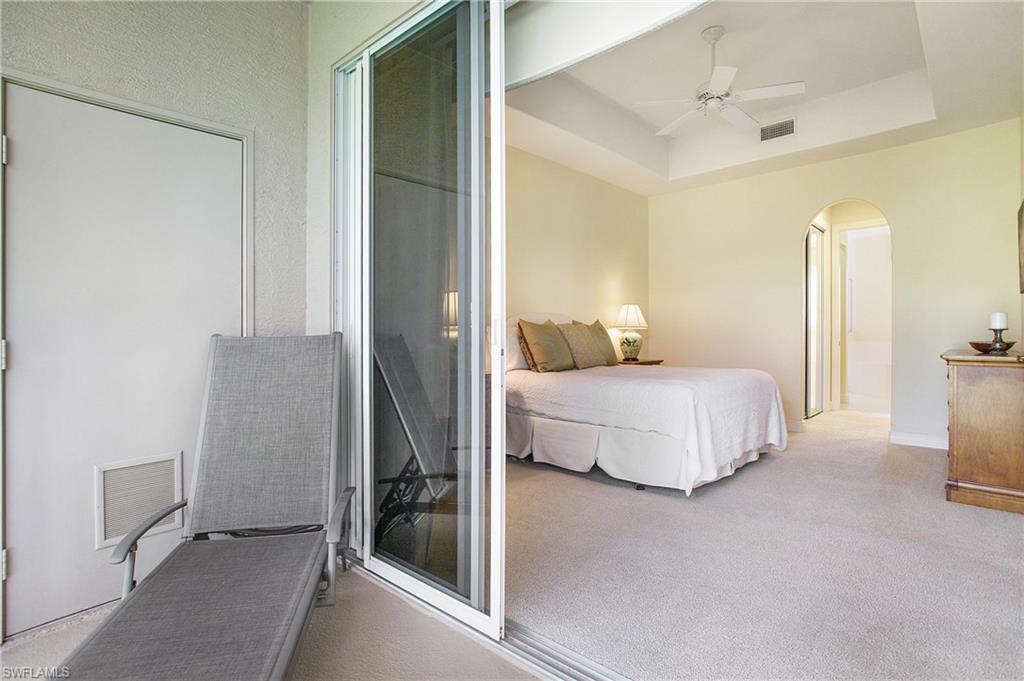 758 Regency Reserve Circle, Unit 2103 Naples, FL 34119 - Photo 31 of 41 a bedroom with a bed and a walk in closet