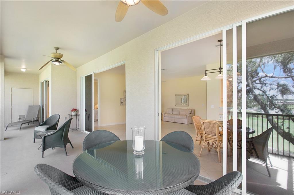 758 Regency Reserve Circle, Unit 2103 Naples, FL 34119 - Photo 35 of 41 a living room with furniture and a glass door