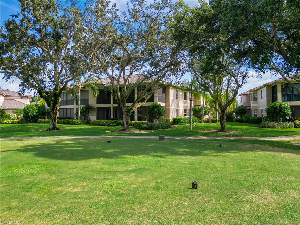 758 Regency Reserve Circle, Unit 2103 Naples, FL 34119 - Photo 38 of 41 a front view of a house with a yard