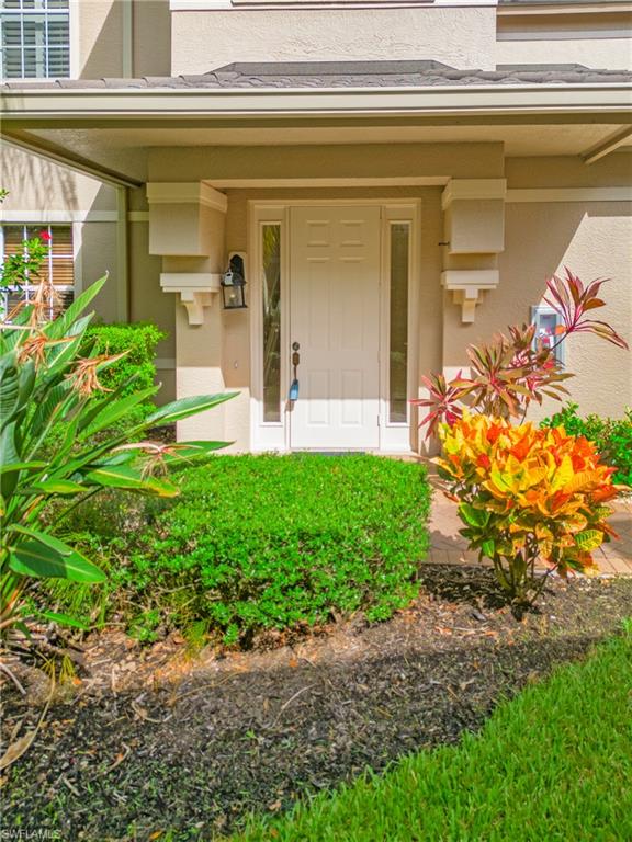 758 Regency Reserve Circle, Unit 2103 Naples, FL 34119 - Photo 5 of 41 a front view of a house with garden