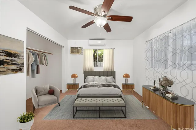 a bedroom with a bed couches dresser and a window