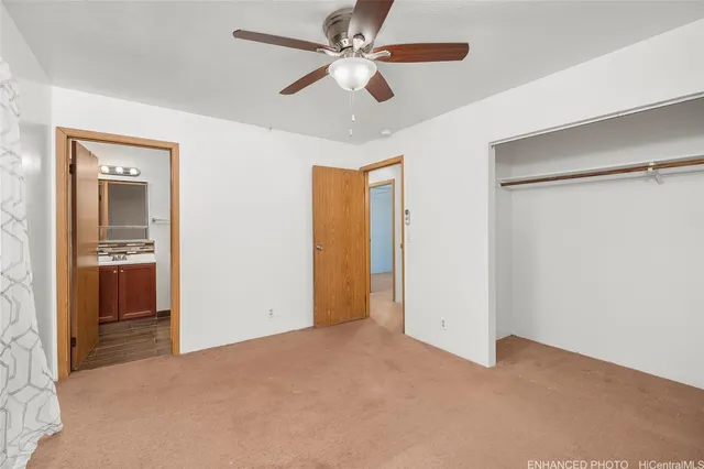 a view of empty room with ceiling fan