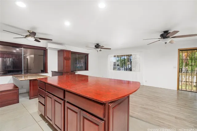 an open kitchen with a sink and living room view