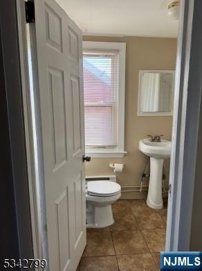 65-67 Monticello Avenue, Unit 3 Newark, NJ 07106 - Photo 7 of 10 a bathroom with a sink toilet and a mirror