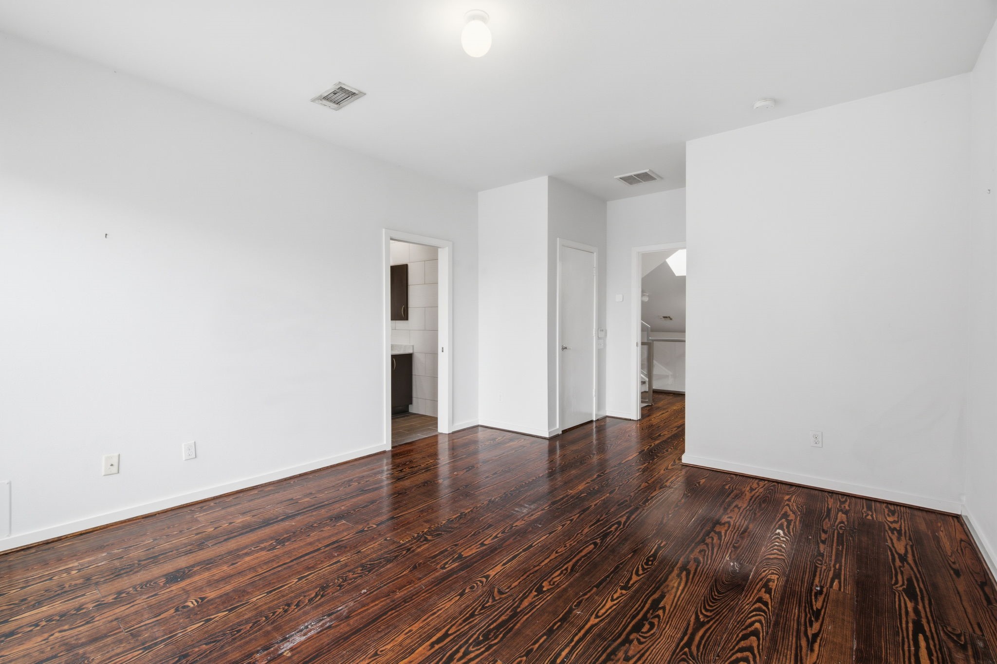 2934 Commerce Street Houston, TX 77003 - Photo 20 of 44 a view of an empty room with wooden floor and a window