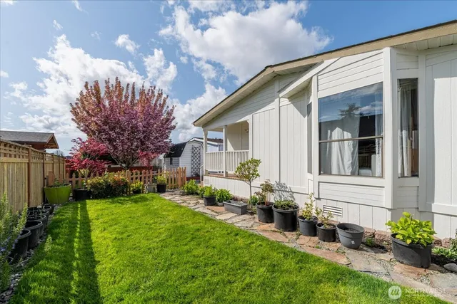 a view of a house with backyard and sitting area