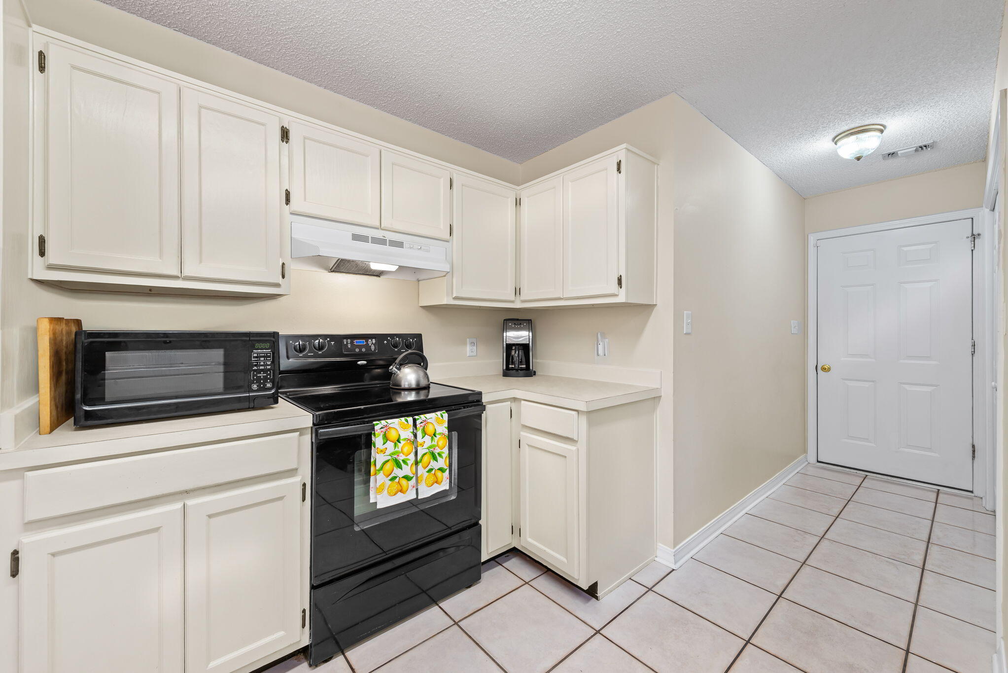 1931 Commodore Drive Navarre, FL 32566 - Photo 9 of 65 kitchen range and door to garage
