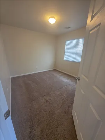 an empty room with a empty space and windows