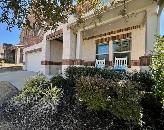 a front view of house with a garden