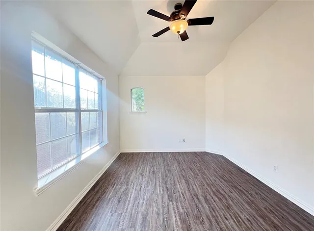 a view of a room with wooden floor and windows