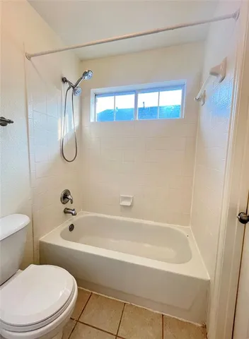 a bathroom with a toilet and a bathtub