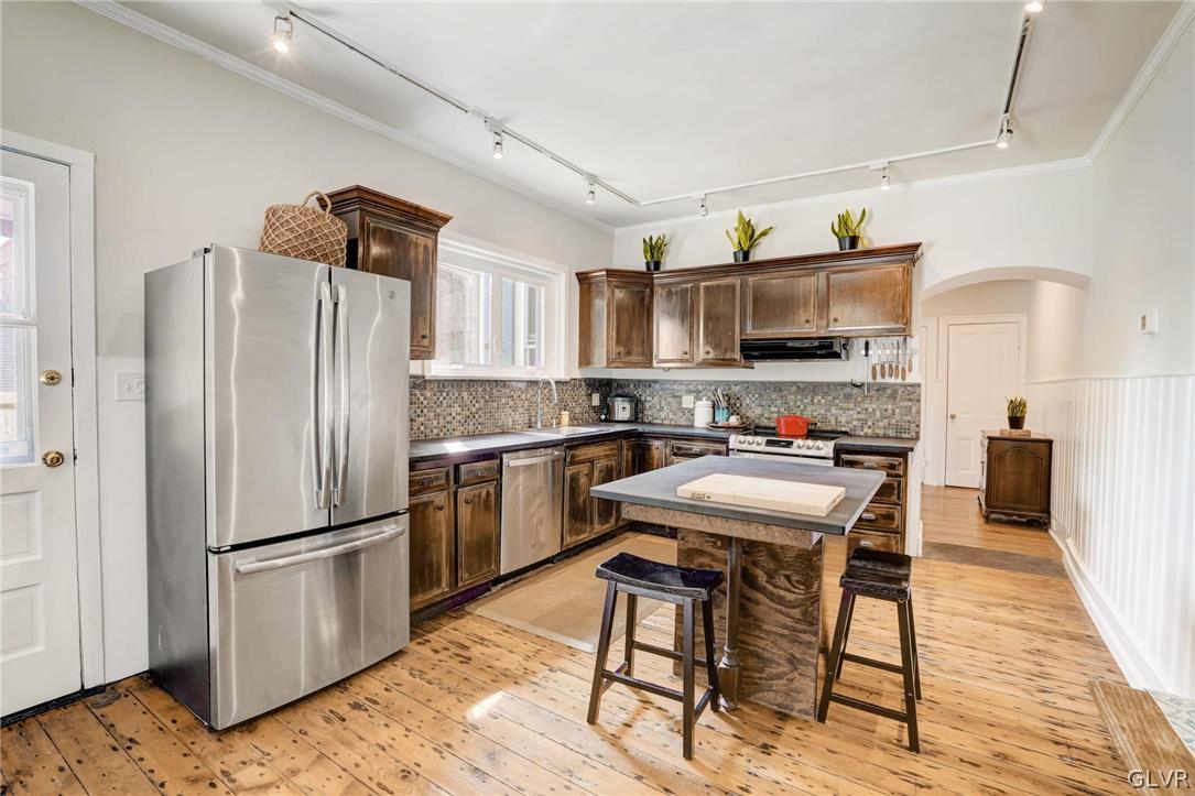 135 Delaware Road Riegelsville, PA 18077 - Photo 17 of 33 a kitchen with stainless steel appliances a stove a refrigerator and a fireplace