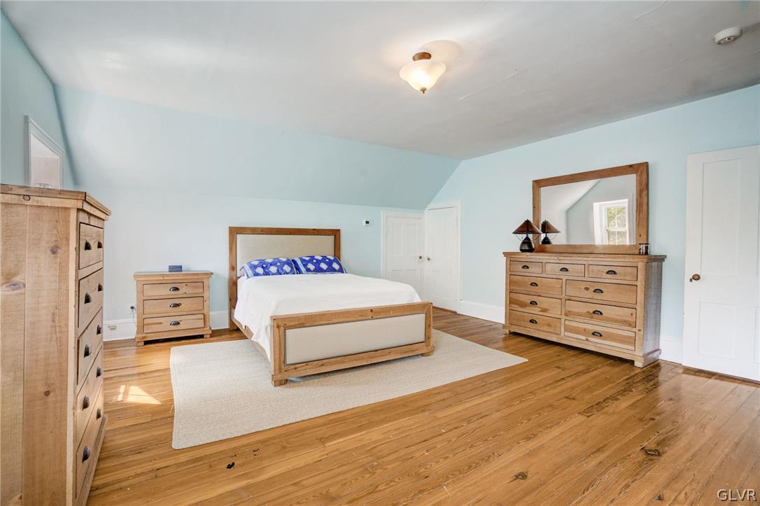 135 Delaware Road Riegelsville, PA 18077 - Photo 22 of 33 a spacious bedroom with a bed and a dresser
