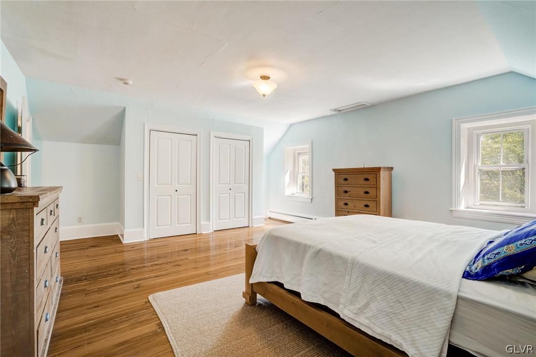 135 Delaware Road Riegelsville, PA 18077 - Photo 23 of 33 a bedroom with a bed and wooden floor