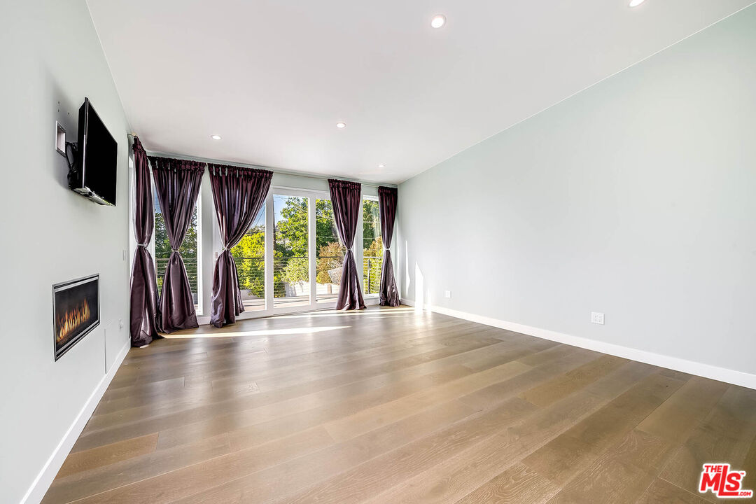 523 East Fairmount Road Burbank, CA 91501 - Photo 20 of 30 a view of an empty room with wooden floor and a fireplace