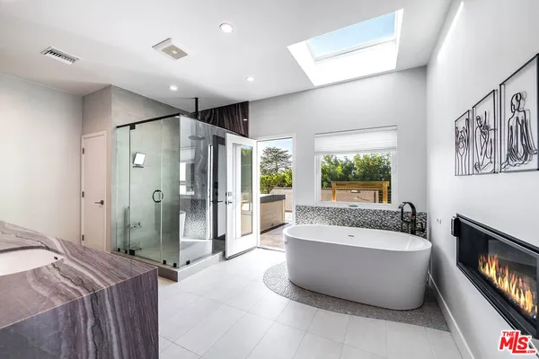 a spacious bathroom with a tub and shower