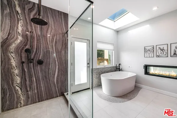 a spacious bathroom with a bathtub and shower