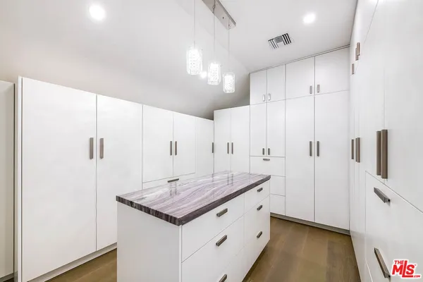 a bathroom with a granite countertop sink a toilet and a shower