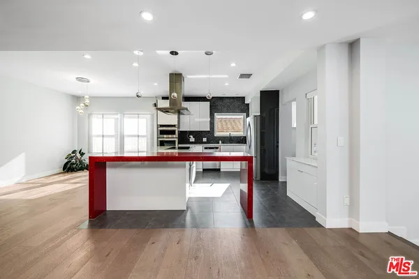 a view of kitchen with cabinets and wooden floor