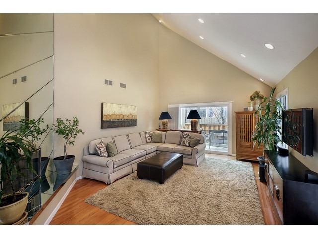 1943 Koehling Road Northbrook, IL 60062 - Photo 3 of 12 a living room with furniture a flat screen tv and a potted plant