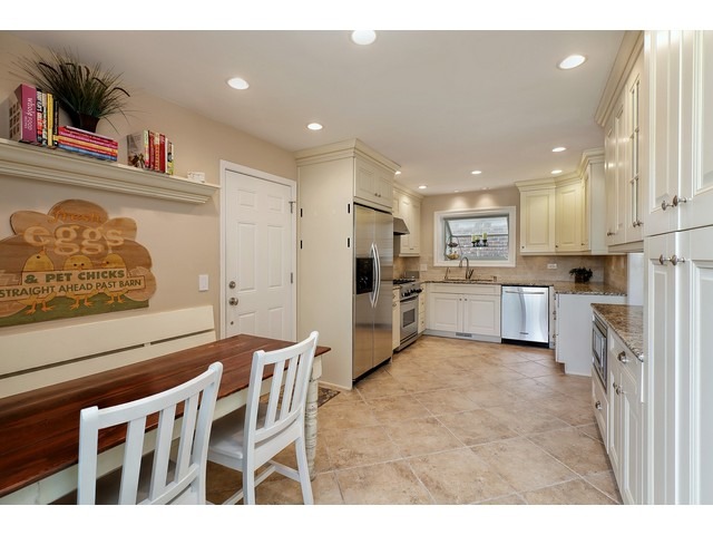 1943 Koehling Road Northbrook, IL 60062 - Photo 6 of 12 a kitchen with stainless steel appliances kitchen island granite countertop a refrigerator and cabinets