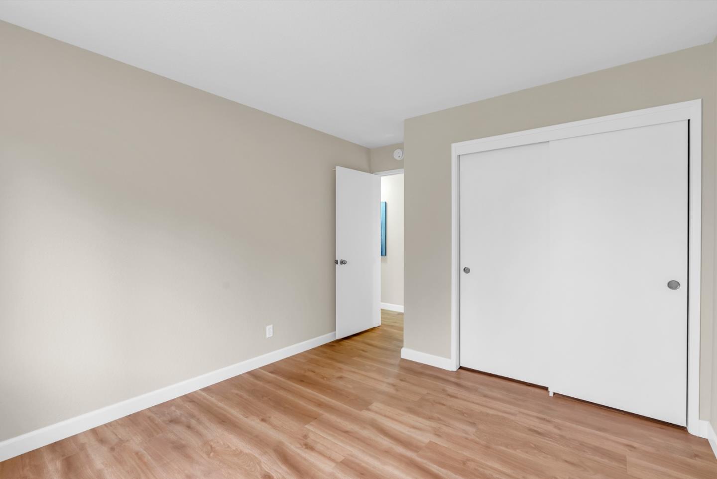 22483 McClellan Road Cupertino, CA 95014 - Photo 16 of 38 a view of an empty room with wooden floor