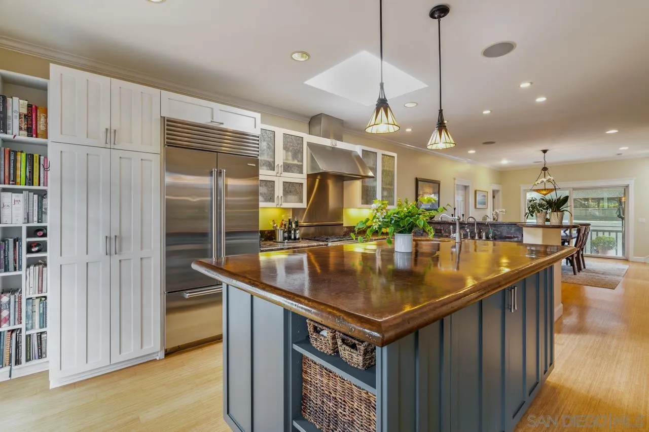 425 Sea Lane La Jolla, CA 92037 - Photo 15 of 41 a kitchen with stainless steel appliances granite countertop a sink a refrigerator and a wooden floor