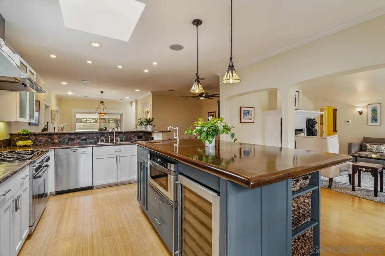 425 Sea Lane La Jolla, CA 92037 - Photo 16 of 41 a kitchen with kitchen island granite countertop a sink a counter top space appliances and cabinets