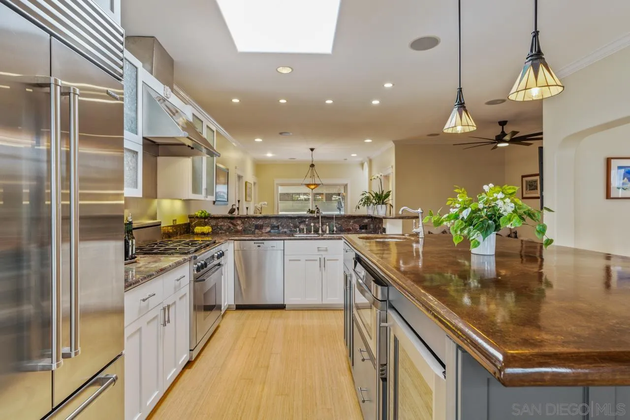 425 Sea Lane La Jolla, CA 92037 - Photo 17 of 41 a kitchen with a sink stainless steel appliances and chandelier