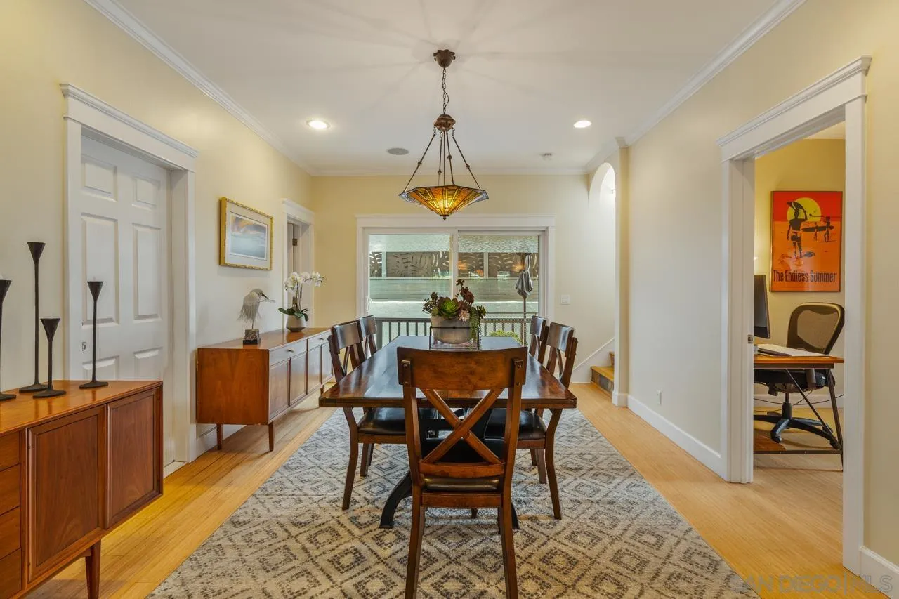 425 Sea Lane La Jolla, CA 92037 - Photo 21 of 41 a dining room with furniture a chandelier and wooden floor
