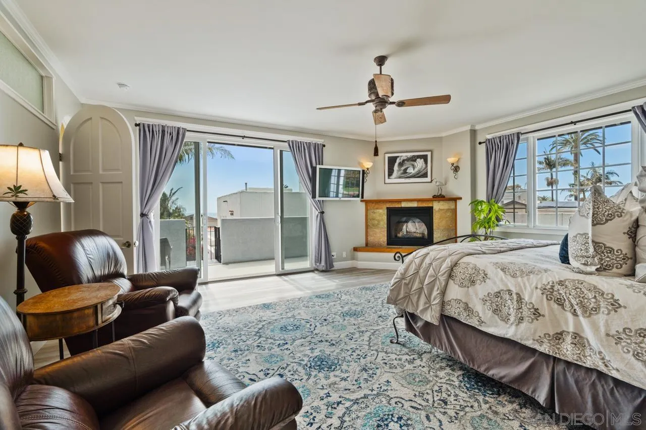 425 Sea Lane La Jolla, CA 92037 - Photo 23 of 41 a bedroom with a bed couch and fireplace