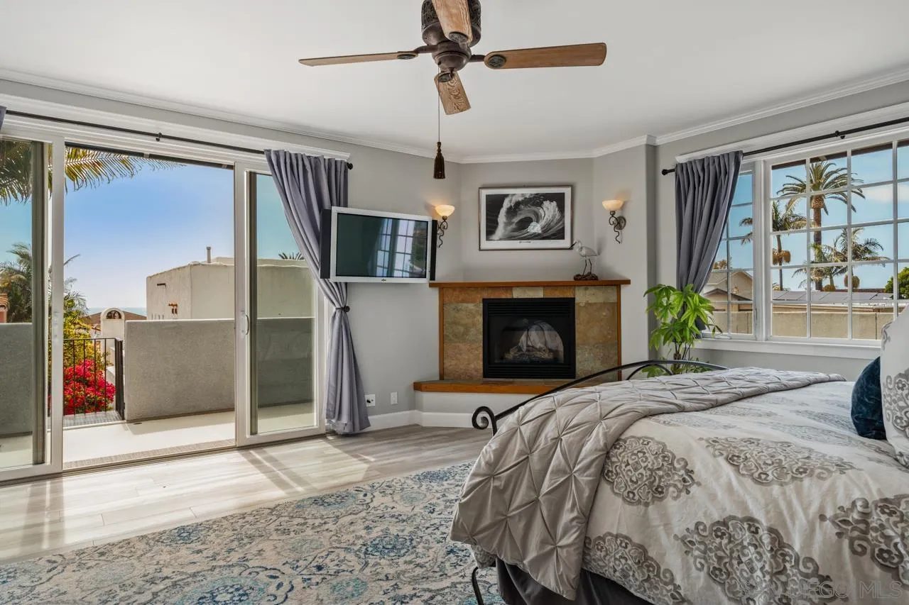 425 Sea Lane La Jolla, CA 92037 - Photo 24 of 41 a bedroom with a bed and a fireplace