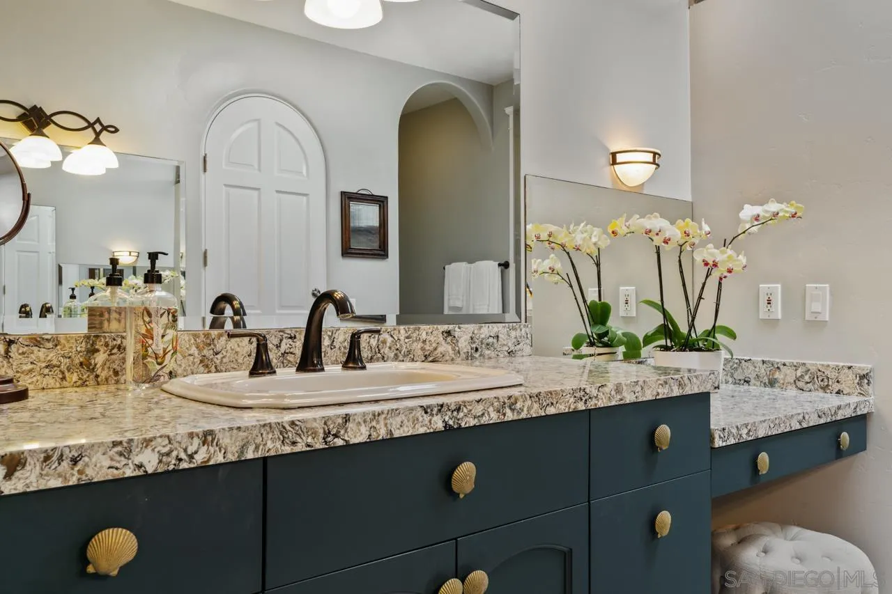 425 Sea Lane La Jolla, CA 92037 - Photo 25 of 41 a bathroom with a granite countertop sink and a mirror